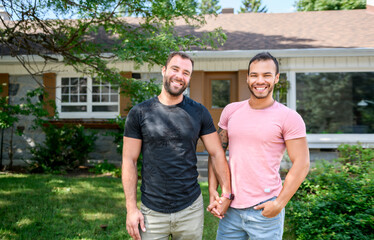 A Portrait of a happy gay couple outdoors in front of a new buy