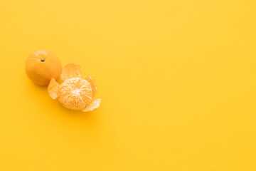 clementine mandarin on a yellow background