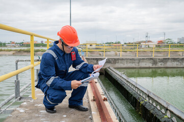 Water plant maintenance technicians, mechanical engineers check the control system at the water treatment plant.