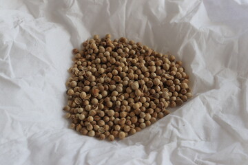Pile of Coriander seeds isolated on white background