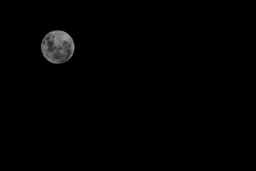 Full moon on the dark sky as a background. Jakarta, Indonesia.