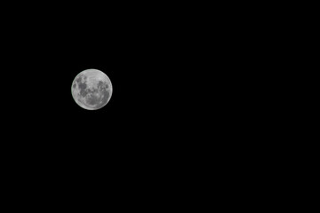 Full moon on the dark sky as a background. Jakarta, Indonesia.