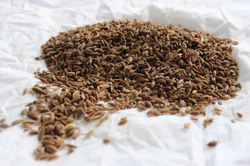 Pile dried of caraway seeds isolated on a white background. Cumin seeds pile isolated on white background. Pile of Carum seeds isolated on white background. Heap of small cumin seeds isolated.