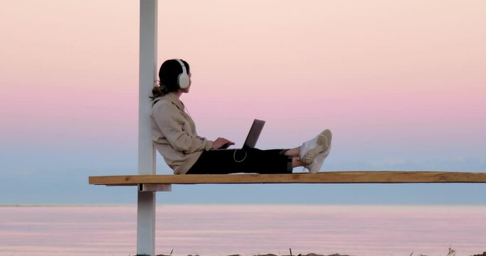 Freelancer working outside with beautiful background of mountains and lake
