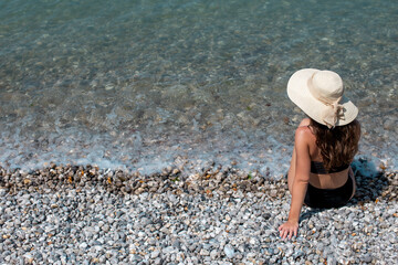 Girl with hat on the beach
