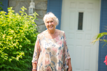 Portrait of senior woman in front of her house