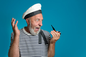 Wow. Old sailor portrait Surprise and admiration. Smoking pipe, marine form. on a blue background...