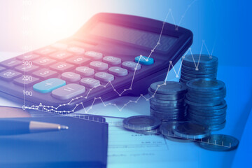 Business data and Financial analytics Concept , pile of coins and calculator