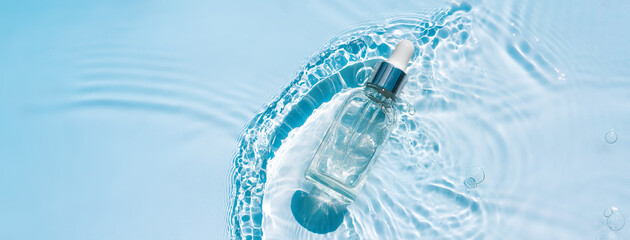Moisturizing serum with hyaluronic acid in a transparent bottle with a pipette on a transparent...