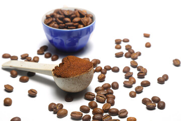 Coffee beans in a wooden scoop isolated on a white background. Roasted coffee beans isolated. A wooden scoop with coffee.
