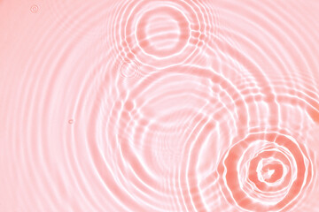 Pink water texture, cosmetic background pink water surface with rings and ripples.