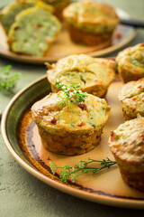 Savory zucchini muffins with herbs, feta cheese and bacon