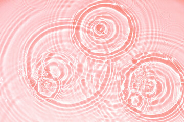 Fototapeta na wymiar Pink water texture, cosmetic background pink water surface with rings and ripples