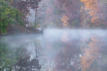 Foggy autumn landscape of the shoreline of Eagle Lake, Fort Custer State Park, Michigan, USA