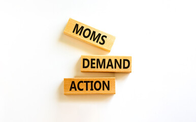Moms demand action symbol. Concept words Moms demand action on wooden blocks on a beautiful white table white background. Business, finacial and Moms demand action concept.