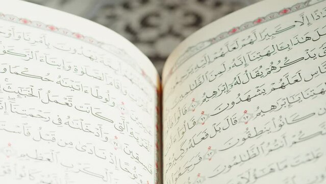 Quran book close-up, praying, islamic religion. Religious holiday Ramadan, holy month. Worship, making traditional prayer to God.