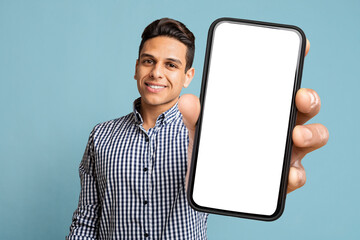 Happy Latino Man Showing Cell Phone With Empty Screen