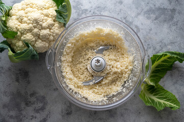 Cauliflower rice in a blender. Fresh cauliflower cooking healthy food, vegan meal, top view