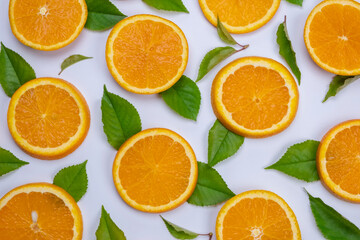 background with slides of orange and leaves on a white background, trendy summer, fruity background