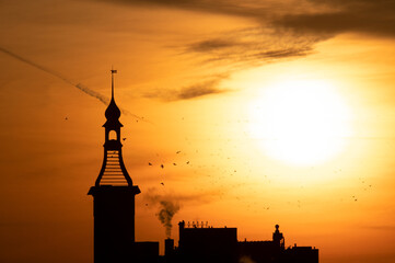 Dark tower at orange dawn