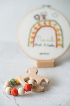 Close-Up of an embroidery hoop and teething toy on a table