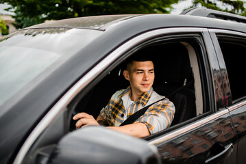 Guy driving a car. view from the street