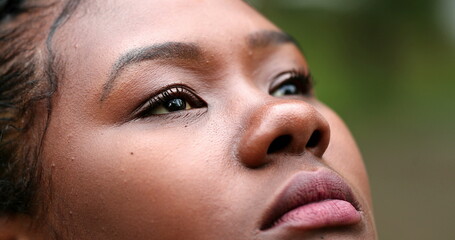 African woman face closing and opening eyes in contemplation