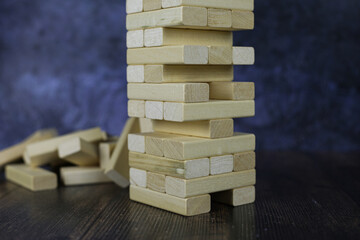 Board game with wooden bricks. Jenga game, wooden tower for playing with friends