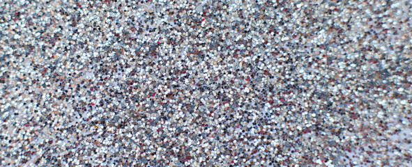 glittering background of silver sequins closeup. Sparkle festive texture