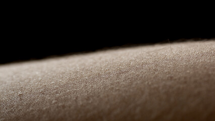 Macro shot of young African American woman's skin on black background | Skin texture shot for woman hair removal concept
