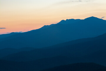 blue ridge mountains at sunset with orange and yellows.