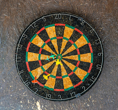 Dart board detail with darts on wall
