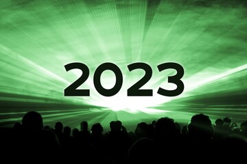 Happy new year 2023 green laser show party people crowd. Luxury entertainment with audience silhouettes turn of the year celebration. Premium nightlife event at holidays season party time