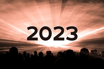 Happy new year 2023 orange laser show party people crowd. Luxury entertainment with audience silhouettes turn of the year celebration. Premium nightlife event at holidays season party time