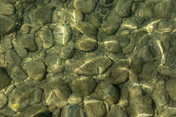 Fototapeta na wymiar View of underwater pebbles in the sea, pebble background