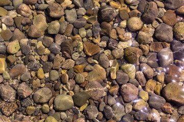 View of underwater pebbles in the sea, pebble background