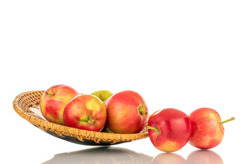 Several ripe sweet red apples on a clay dish, close-up, isolated on a white background