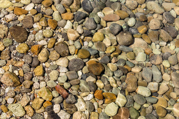 View of underwater pebbles in the sea, pebble background