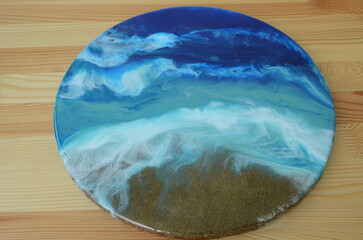 Epoxy resin art. Imitation of the sea. Sea foam. Modern trendy hobby. Macro photo. DIY process