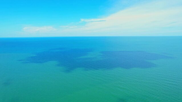 4K drone aerial view of beautiful ocean waves, fly over the sea, small waves in the sea. sea in the tropics. Background footage for summer. cinematic drone shot. Phetchaburi, Thailand
