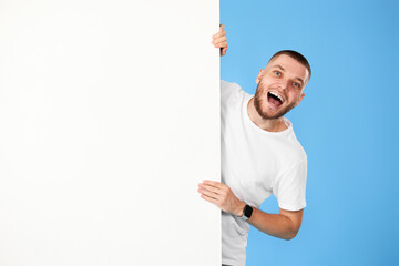 cheerful man holding board with empty copy space