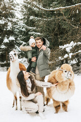 family of three young beautiful woman and man fashion stylish winter clothes overall, baby boy son...