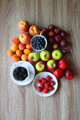 Various healthy seasonal food arranged on wooden background. Flat lay.