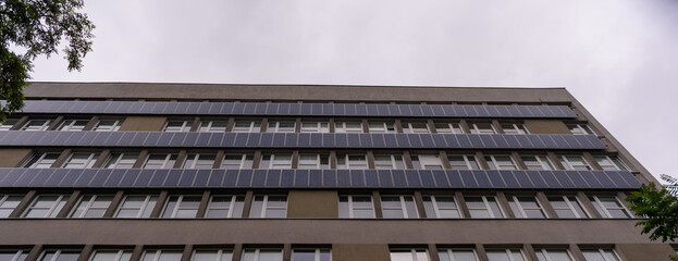 building against the sky, solar panels on the building