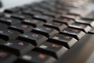 Keyboard close-up with cyrillic and latin characters. English and Russian language on computer keyboard.