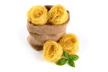 Italian pasta tagliatelle nest isolated on white background. Italian rolled fresh fettuccine pasta, isolated on white background.
