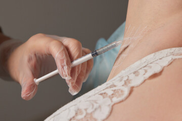 The doctor makes intramuscular injections of botulinum toxin.