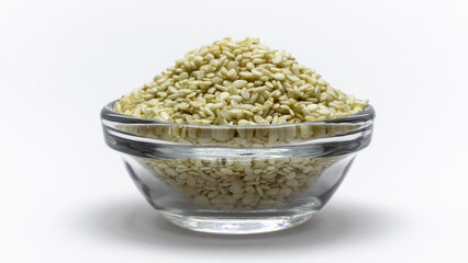 sesame seeds, in a glass plate on a white background