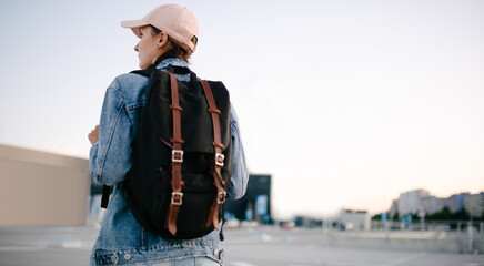 Tourist girl with her backpack looking at city landscape, back view Adventure and travel in the concept . Backpack rear view. Tourism in city. - 519446585