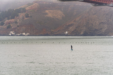 Man riding a hydrofoil surfboard.